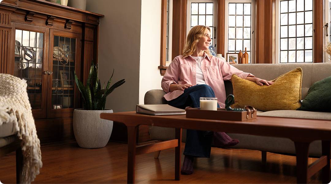 A woman relaxing on her living room sofa